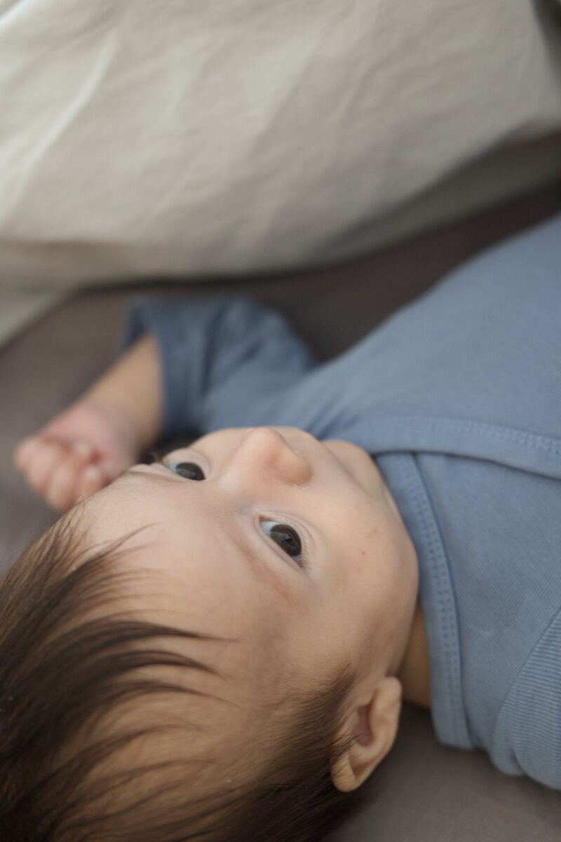 Close-up of baby looking up with wide eyes